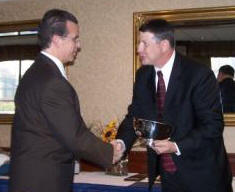 Dr. Schultz (left) accepts congratulations from TMS Executive Director Phillip Samblanet (right) after receiving the 2007 Scalzi Research Award.