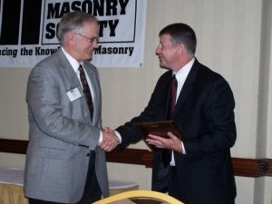 Dr. Russell H. Brown (left) is congratulated by TMS Executive Director Phillip Samblanet during the presentation of Brown's Honorary Membership plaque at The Masonry Society's 2006 Annual Meeting in Atlanta, Georgia.
