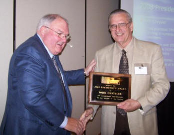 TMS President Ray Miller (left) congratulates John Chrysler (right), recipient of the 2008 President's Award.