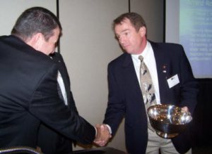 David McLean (right) is congratulated by TMS Executive Director Phil Samblanet after winning the 2008 Scalzi Research Award. 