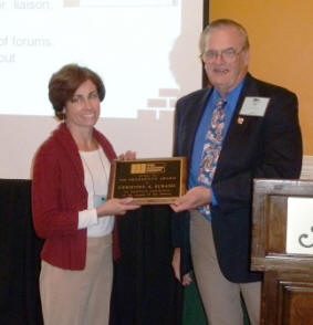 TMS President John Chrysler congratulates Tina Subasic on receiving the 2011 President's Award during the Annual Meeting Awards Luncheon.