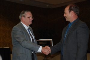 Scott Walkowicz (right) is congratulated by John Chrysler (left) after being presented with the 2010 President's Award.