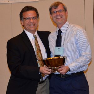 Dr. Auturo Schultz, Chairman of TMS's Research Committee, congratulates Dr. Bennett after presenting him with the 2014 Scalzi Research Award.