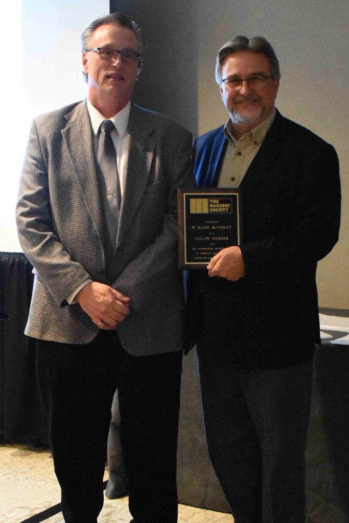 Dr. W. Mark McGinley (left) receives his Fellow Membership by TMS President Darrell McMillian